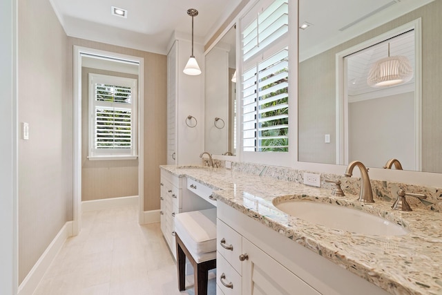 bathroom featuring vanity, a wealth of natural light, and ornamental molding