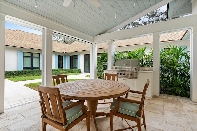 sunroom / solarium featuring lofted ceiling and ceiling fan