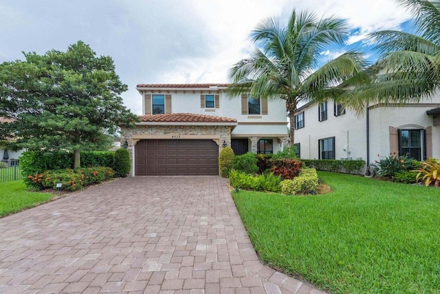 mediterranean / spanish-style house with a front yard and a garage