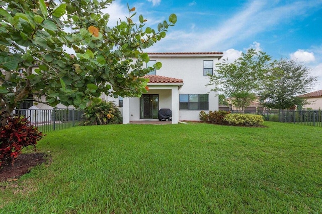 rear view of house featuring a lawn