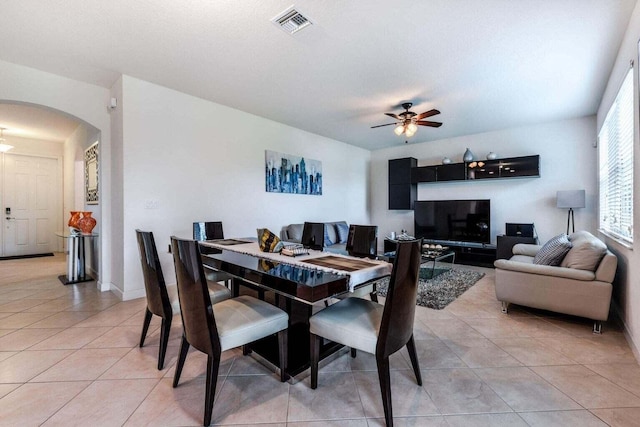 tiled dining room featuring ceiling fan and a textured ceiling