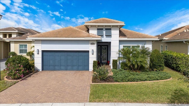 view of front of house featuring a garage and a front lawn