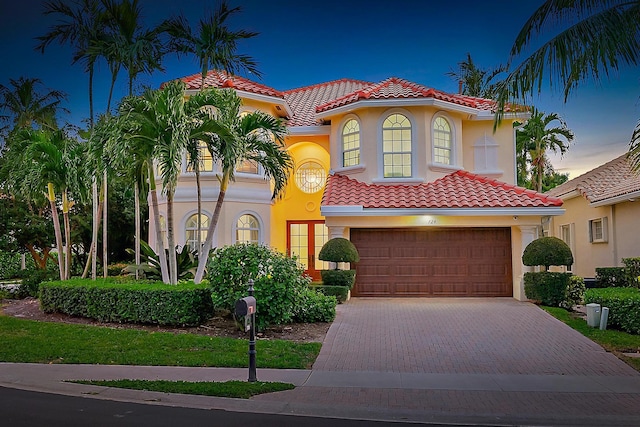 mediterranean / spanish-style house with a garage