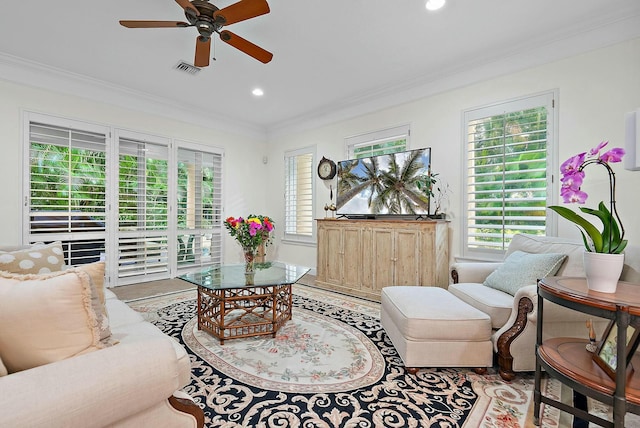 living room with ceiling fan and crown molding