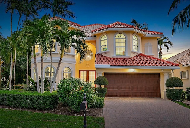 mediterranean / spanish home with a garage