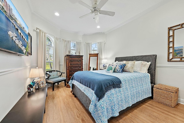 bedroom featuring ceiling fan, crown molding, and wood-type flooring