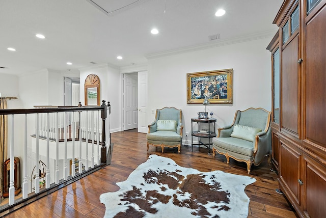 sitting room featuring dark hardwood / wood-style flooring and ornamental molding