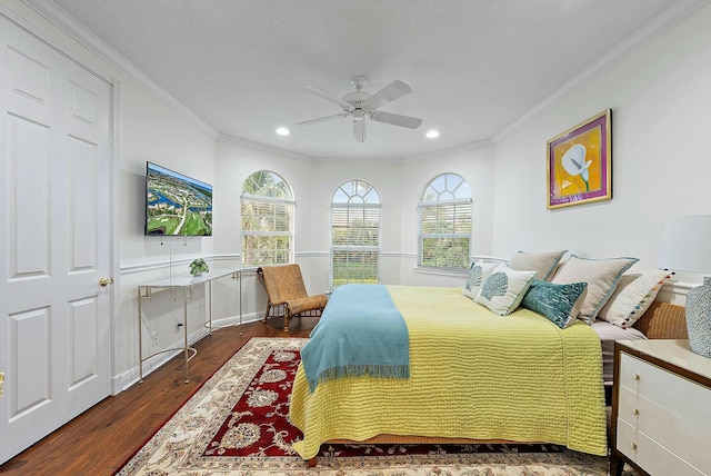 bedroom with ceiling fan, dark hardwood / wood-style flooring, and crown molding