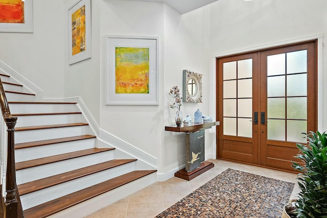 entryway featuring french doors and light tile patterned flooring