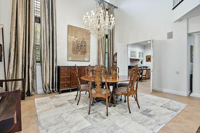 tiled dining space with a chandelier and a towering ceiling