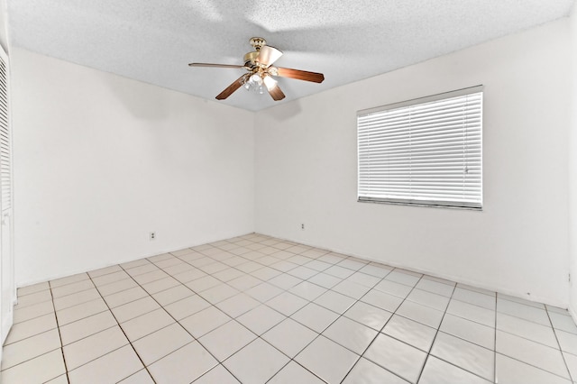 spare room featuring a textured ceiling and ceiling fan