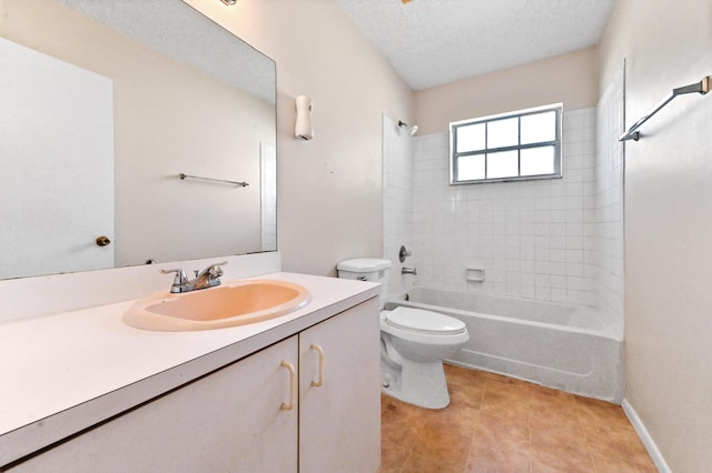 full bathroom featuring tile patterned flooring, tiled shower / bath combo, vanity, a textured ceiling, and toilet