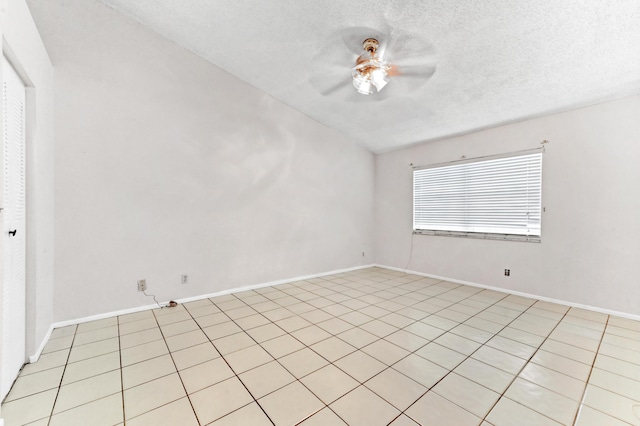 unfurnished room with ceiling fan and a textured ceiling