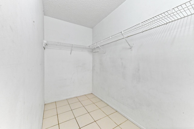 spacious closet with light tile patterned floors