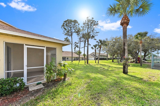 view of yard with a sunroom