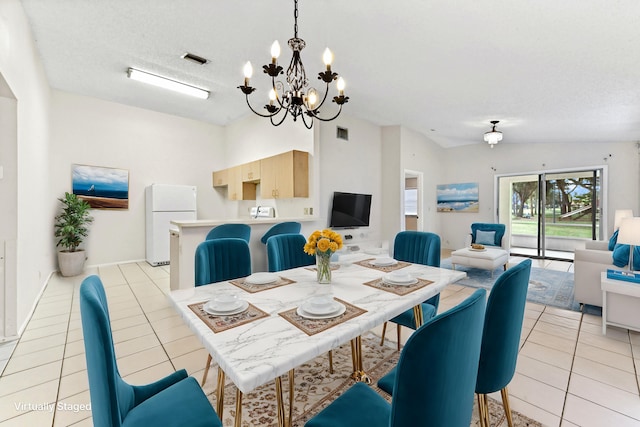 dining area with light tile patterned floors, vaulted ceiling, and a textured ceiling