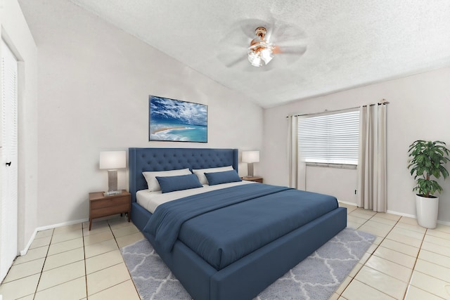 bedroom with ceiling fan, lofted ceiling, light tile patterned floors, and a textured ceiling