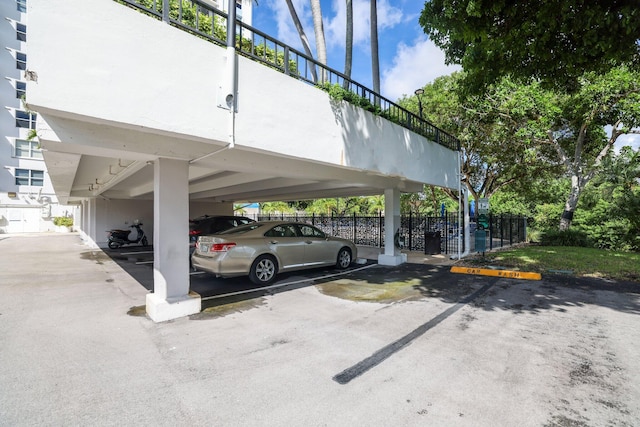 view of parking / parking lot featuring a carport