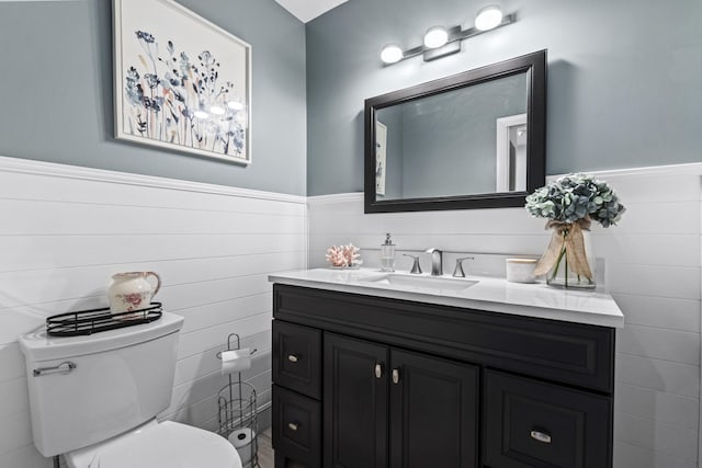 bathroom featuring toilet and vanity