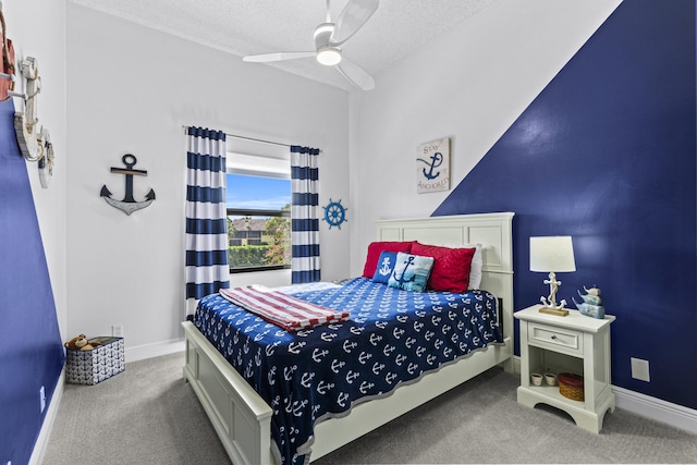 carpeted bedroom with ceiling fan and a textured ceiling