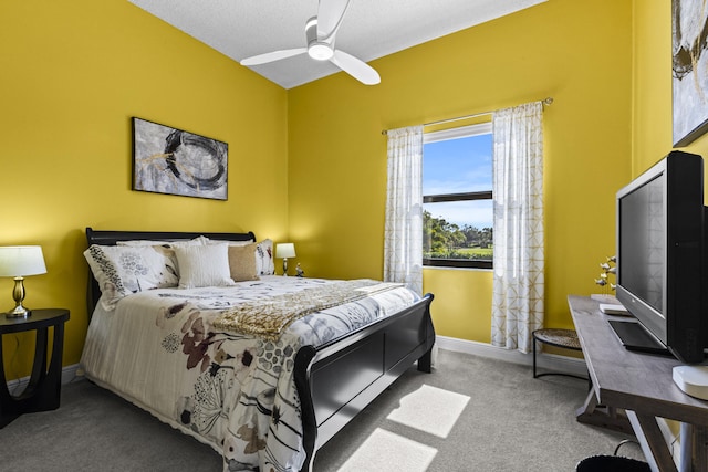 carpeted bedroom featuring a textured ceiling and ceiling fan