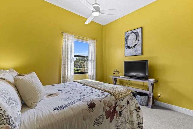 bedroom featuring ceiling fan and carpet