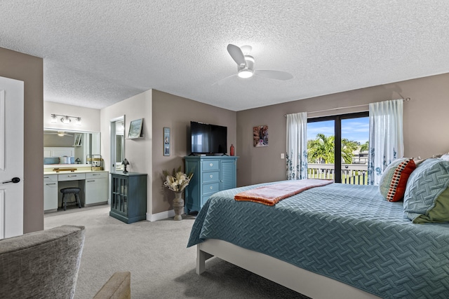 bedroom featuring light carpet, ceiling fan, a textured ceiling, and access to outside