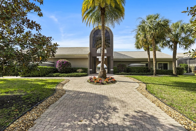 ranch-style home with a front lawn