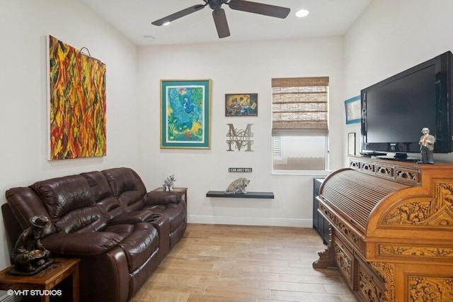 living room with ceiling fan and light hardwood / wood-style floors