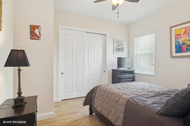 bedroom featuring ceiling fan, a closet, and light hardwood / wood-style flooring