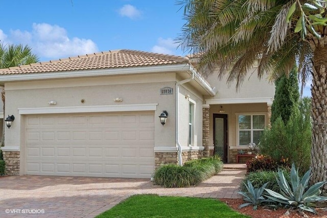 mediterranean / spanish home featuring a garage