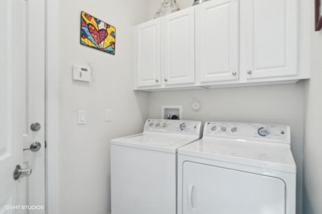 laundry room with cabinets and washing machine and dryer