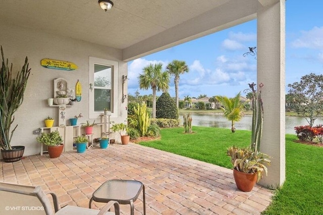 view of patio with a water view