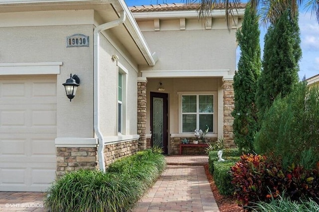 view of exterior entry featuring a garage