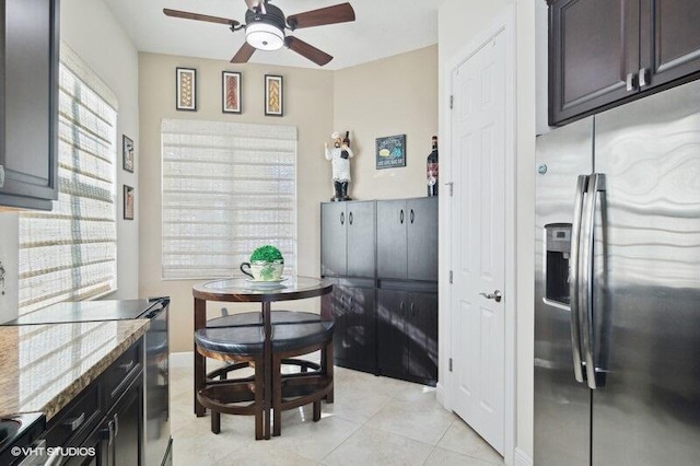 dining area featuring ceiling fan and light tile patterned floors