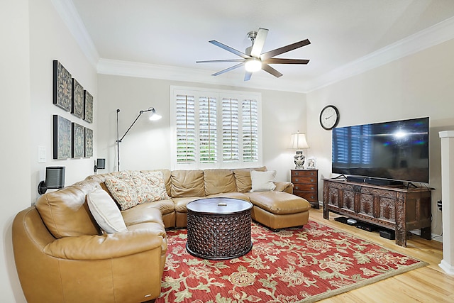 living room featuring hardwood / wood-style flooring, ornamental molding, and ceiling fan