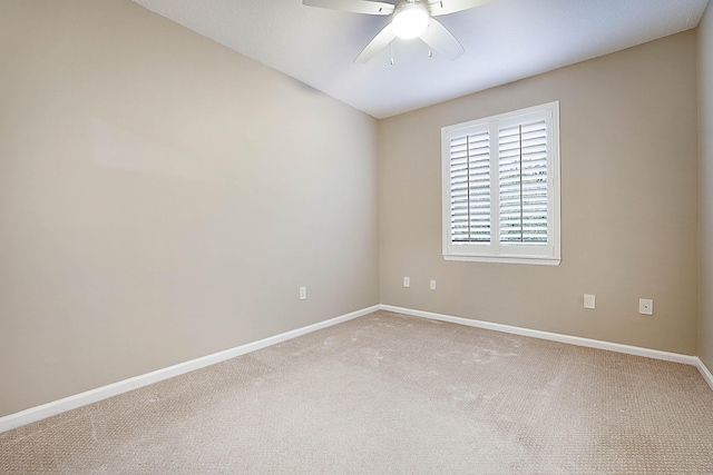 empty room featuring ceiling fan and light colored carpet