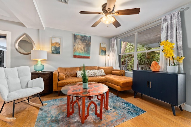 living room featuring ceiling fan and hardwood / wood-style floors