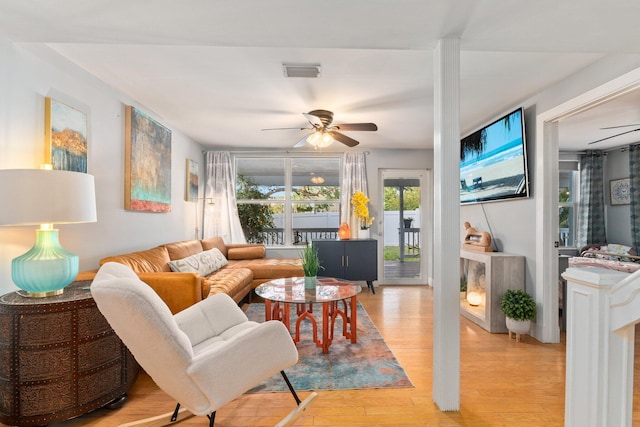 living room featuring ceiling fan and light wood-type flooring