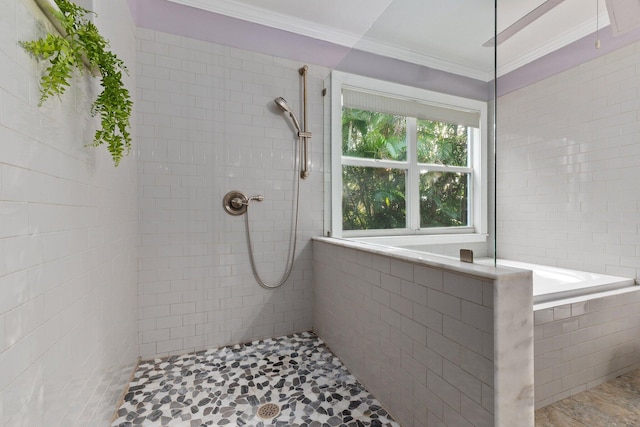 bathroom with ornamental molding and a tile shower