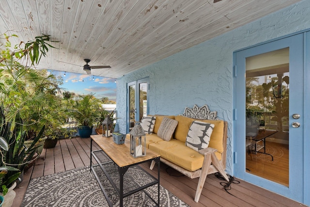 deck with ceiling fan and an outdoor living space