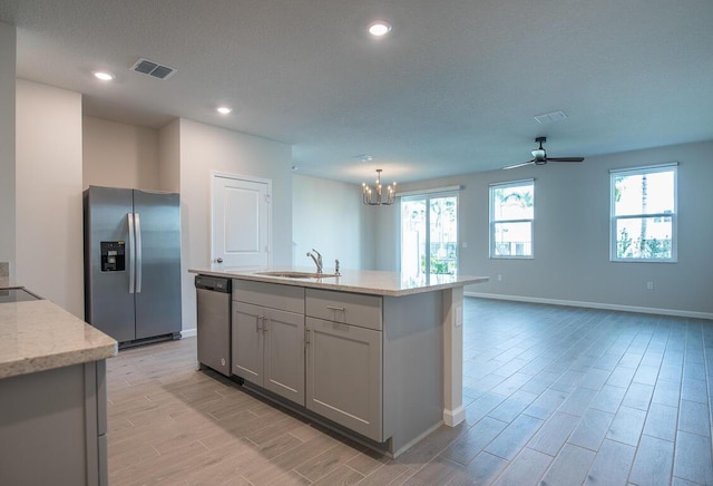 kitchen featuring sink, a wealth of natural light, a center island with sink, and stainless steel appliances