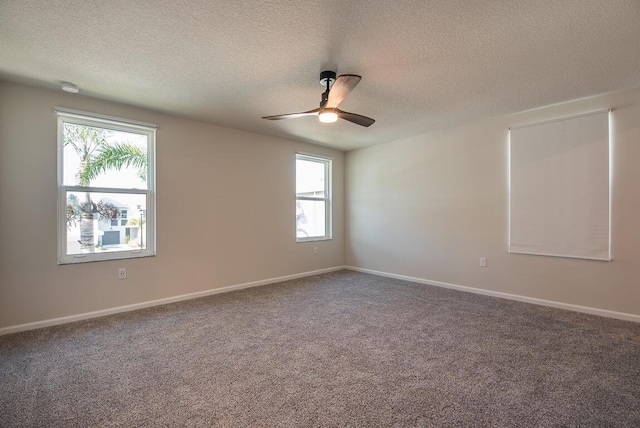 carpeted empty room with ceiling fan and a textured ceiling