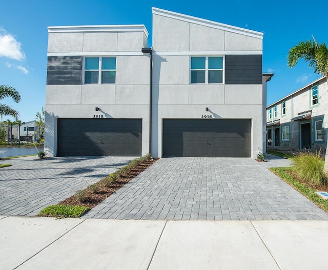 contemporary home with a water view and a garage