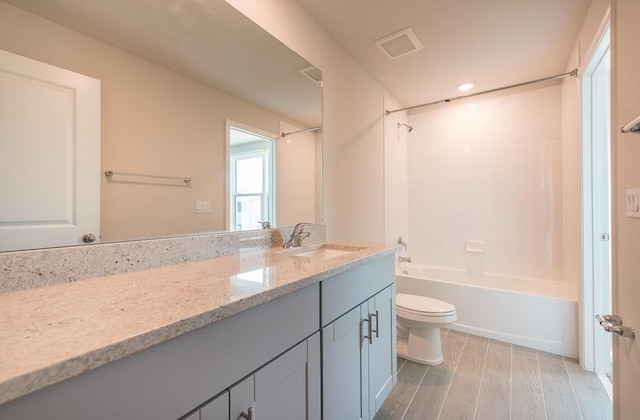 full bathroom featuring toilet, shower / bathtub combination, and vanity