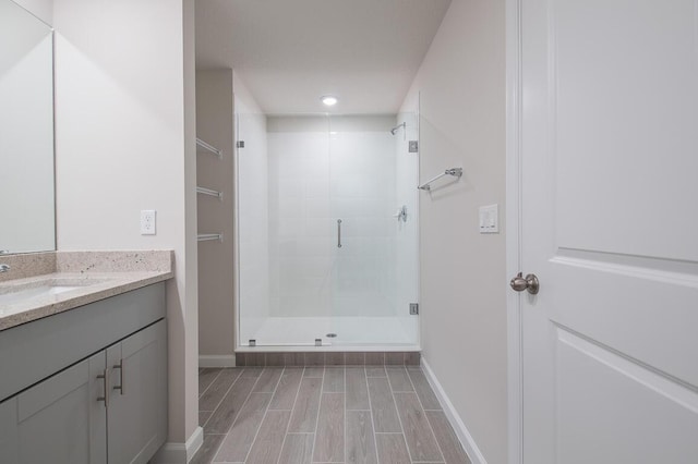 bathroom with an enclosed shower and vanity