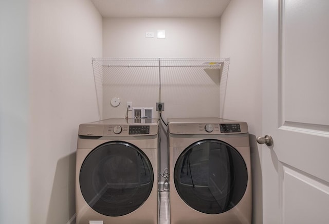 clothes washing area featuring washing machine and clothes dryer