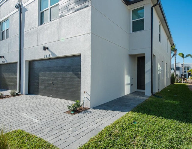 view of property exterior featuring a garage and a yard