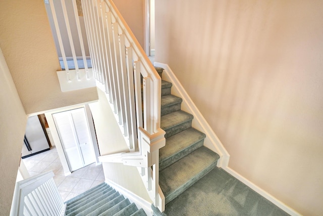 stairs with tile patterned flooring