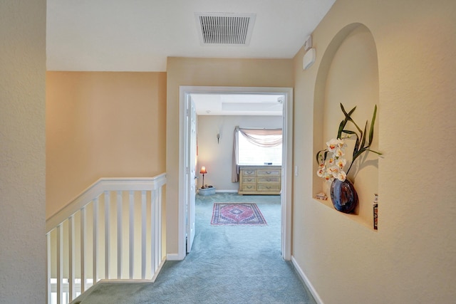 hallway with light colored carpet